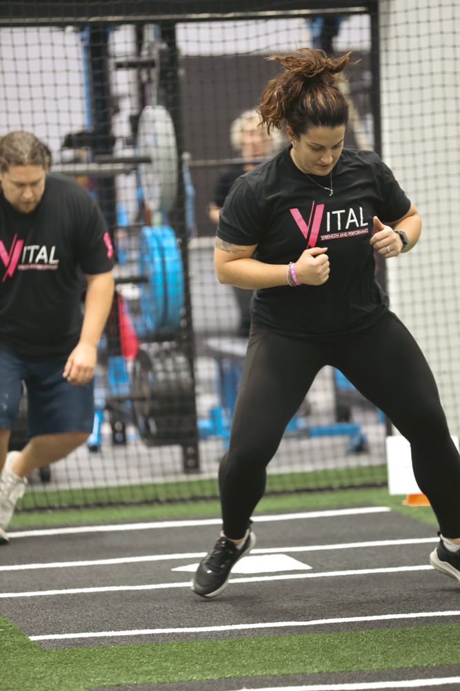 VITAL member lifting a medicine ball during a coached conditioning circuit
